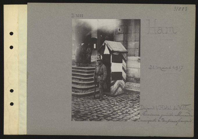 Ham. Devant l'hôtel de ville : ancienne guérite allemande recouverte de drapeaux français