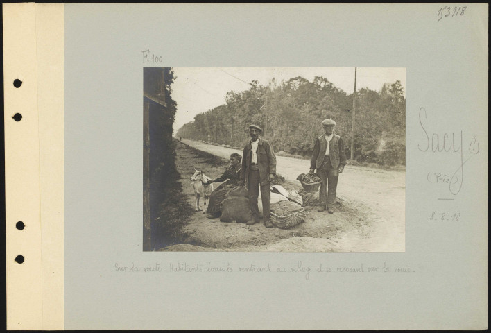 Sacy (?) (près). Sur la route. Habitants évacués rentrant au village et se reposant sur la route