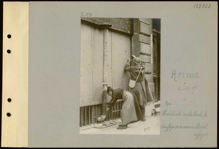 Reims. Rue ? Habitante installant le chauffage de sa cave où elle est réfugiée