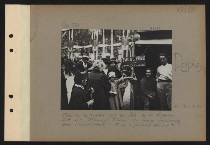 Paris. Fête du 14 juillet 1919 ou fête de la Victoire. Avenue des Champs-Élysées. Un tronc improvisé avec l'inscription "Pour le pinard des poilus"