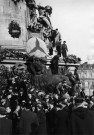 La manifestation du Front Populaire, Place de la République, en commémoration des journées des 9 et 12 février 1934. Sous-Titre : Des membres des jeunesses socialistes accrochent des couronnes sur le monument de la République.