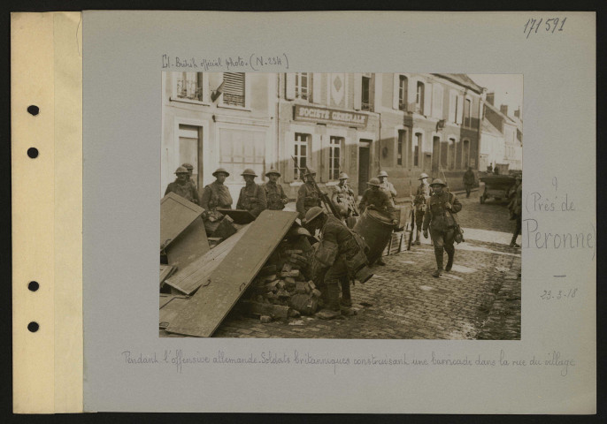 ? (Près de Péronne). Pendant l'offensive allemande. Soldats britanniques construisant une barricade dans la rue du village